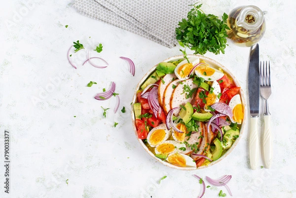 Fototapeta Healthy cobb salad with chicken, avocado, tomato, red onions and eggs. American food. Top view, overhead