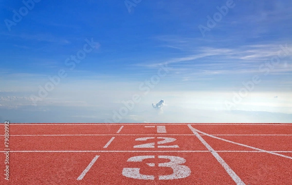 Fototapeta running track number standard red color under the blue sky.