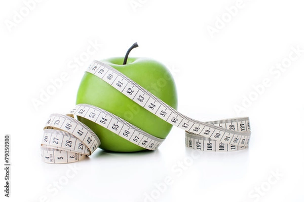 Fototapeta Green apple with measuring tape