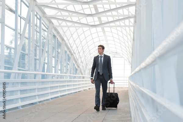 Obraz Businessman walking in urban environment of airport