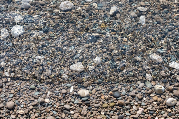 Obraz Summer view of clear sea water and small rocks