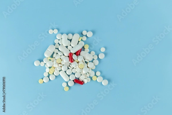 Obraz Various medicines are scattered on a blue background