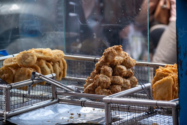 Fototapeta Gorengan is a typical snack from Indonesia. It usually consists of tempeh, tofu, cassava, and bananas. Gorengan is one of the people's favorite street foods in Indonesia.