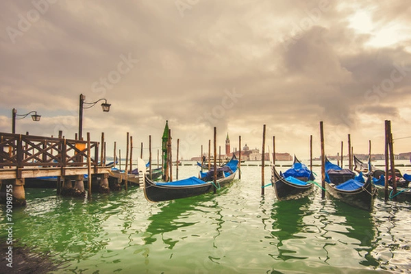 Fototapeta Gondolas docked to the poles on the Grand Canal in Venice.