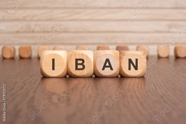 Obraz the text IBAN is written on wooden cubes on a brown background