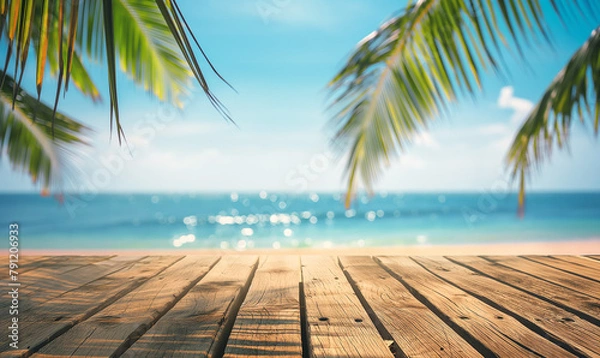 Fototapeta Wooden table top with wooden planks and blurred beach background, palm leaves and blue sky in summer for product display montage