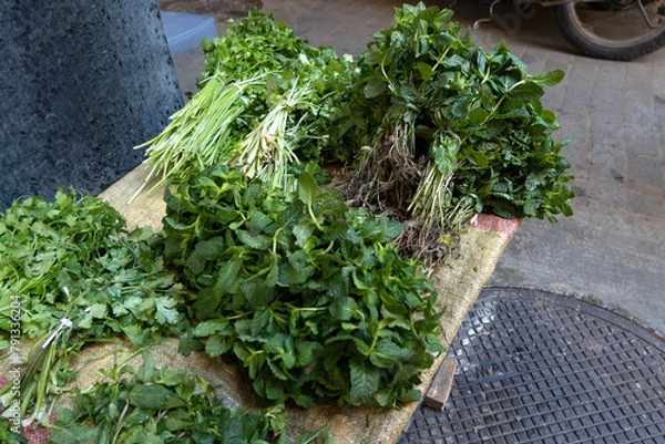 Obraz Different fresh aromatic herbs, mint, coriander on outdoor stall. Medina souk, Fez Morocco
