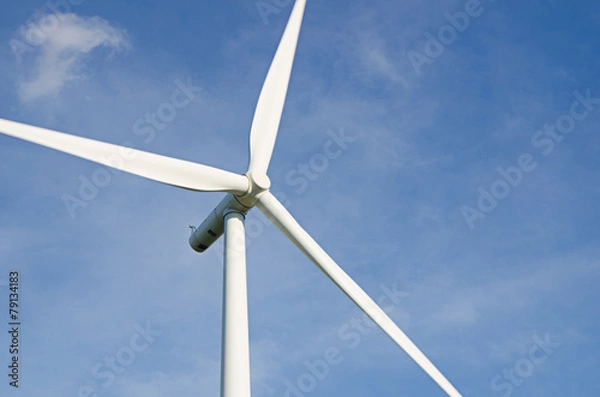 Obraz wind turbine against cloudy blue sky background