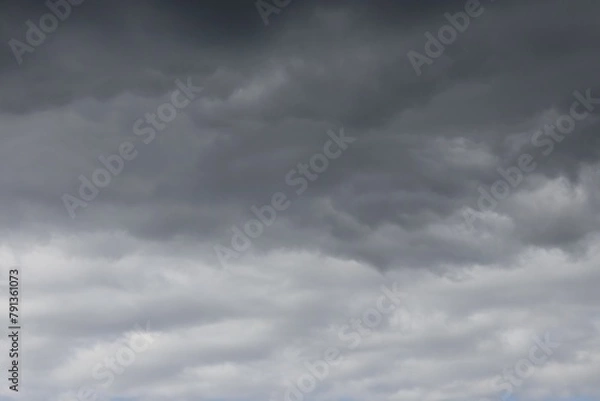 Obraz dark rain clouds with some lighter clouds in the background