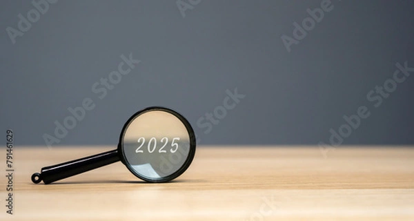 Fototapeta Magnifying glass with the inscription 2025. Setting goals and objectives for the new year. Planning, business management and strategy concept. Trends and ideas. Vision.