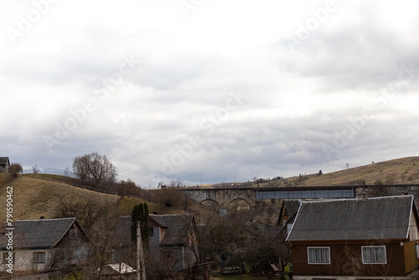 Fototapeta sky with white clouds over the house in the mountains