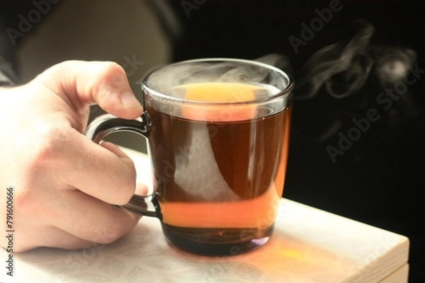 Fototapeta A man drinks hot tea