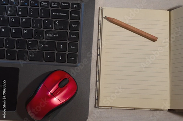 Fototapeta computer keyboard or notebook, with a red mouse and notepad with pencil, work at home concept