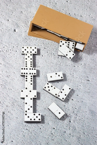 Obraz Aligned dominoes: the magic of the domino game. Concept of strategy and planning.