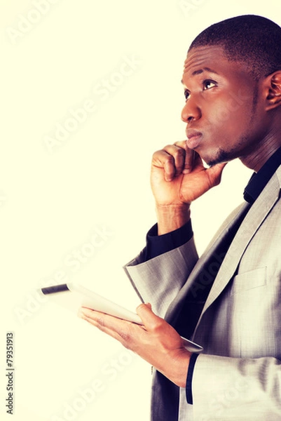 Obraz Thoughtful businessman using digital tablet.
