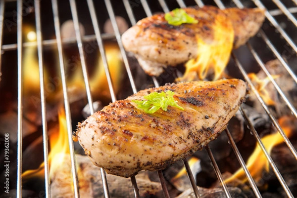Obraz Marinated grilled chicken on the flaming grill