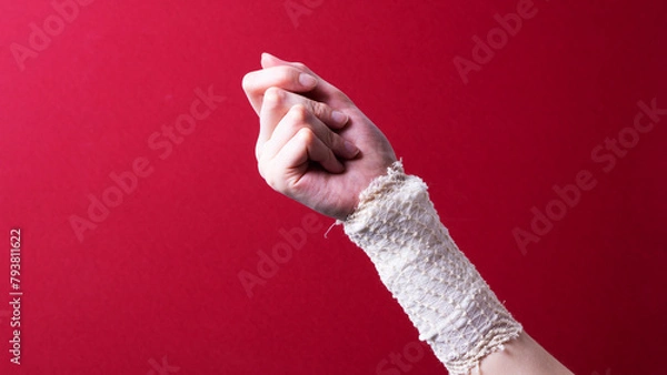 Obraz a bandaged female hand on a colored background