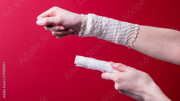 Obraz a bandaged female hand on a colored background