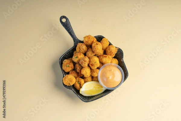 Fototapeta Crunchy chicken popcorn served with peri peri mayo sauce