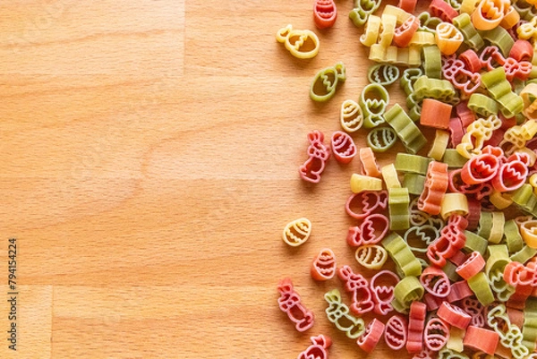 Fototapeta Colorful Easter pasta on a wooden cutting board