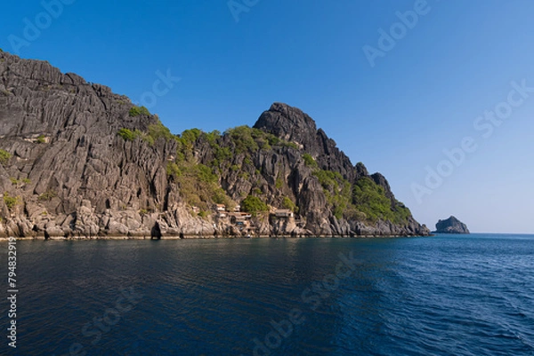 Obraz Scenic view of a hidden village by the sea, surrounded by towering rock formations at Chumporn sea, Thailand