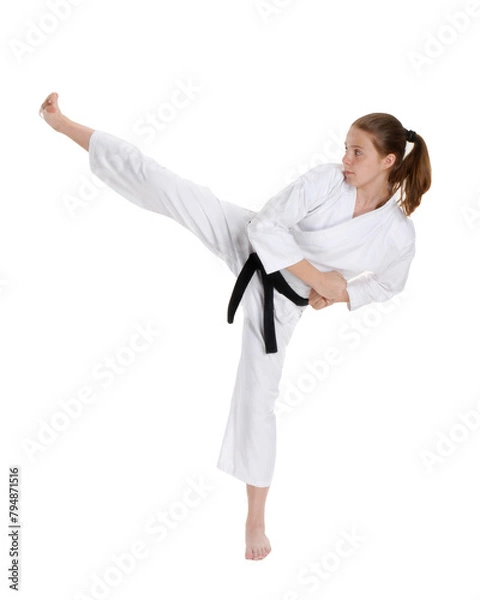 Obraz Female Karate kid kicking isolated on transparent layered background.