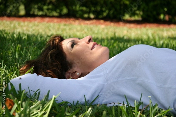 Fototapeta girl lying on the grass