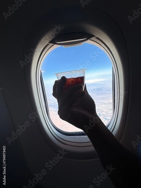 Obraz Enjoying a beverage on a flight