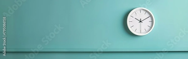 Fototapeta A clock attached to a monochromatic wall in a room, displaying the time