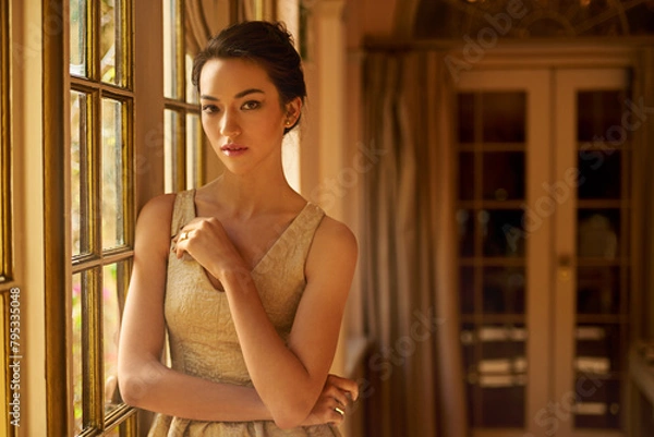 Fototapeta Fashion, window and portrait of elegant woman in home for gala event in style, classy outfit and dress. Wealth, aesthetic and person with confidence, pride and glow in vintage manor, house or mansion
