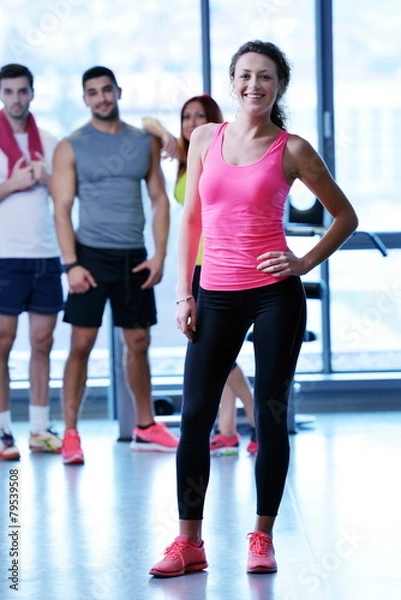 Fototapeta Group of people exercising at the gym