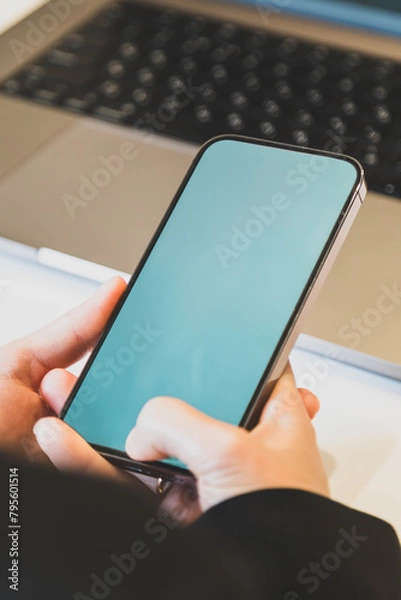 Obraz girl holding a smartphone in her hands in the office close up