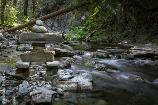 Fototapeta Inukshuk in the raging river.
