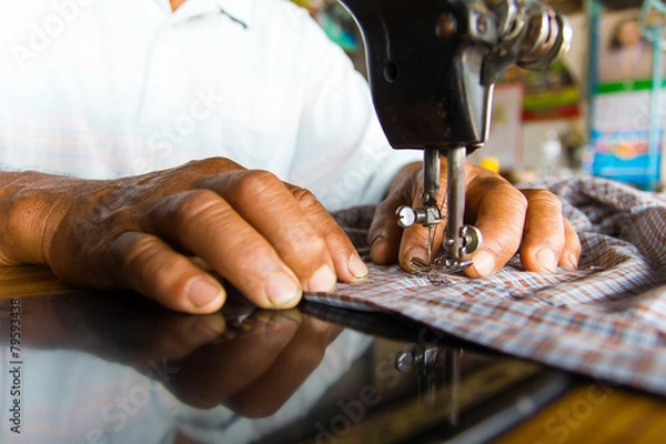 Fototapeta Man with a sewing machine