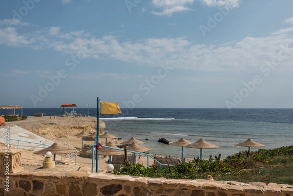 Obraz yellow flag at the beach on vacation in egypt