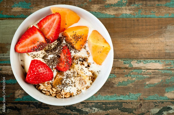Obraz Healthy breakfast of muesli strawberries and melon.