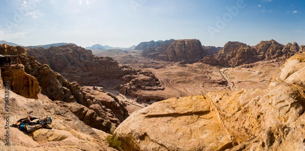 Fototapeta A view from above of the valley of the archeological site of Petra in Jordan with a view of the Nabatean Theatre and Qasr al-Bint
