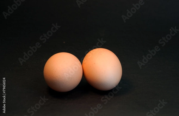 Fototapeta Two eggs on black background