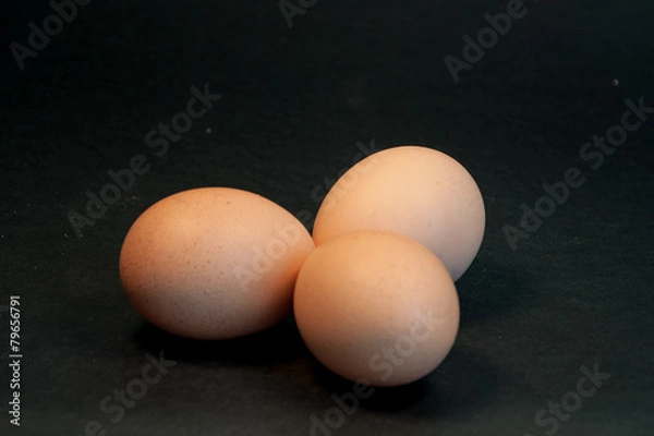 Obraz Three eggs on the black background