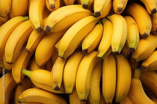 Fototapeta Several ripe bananas stacked on top of each other.