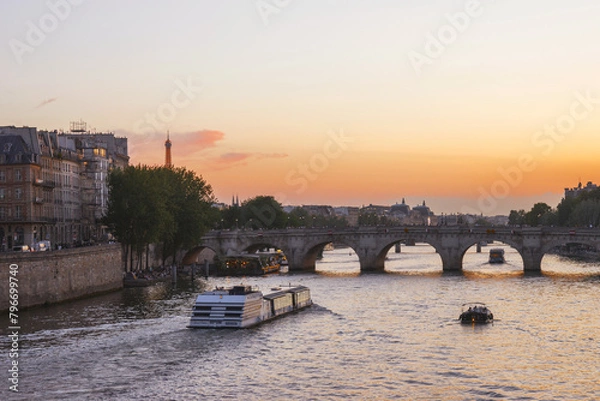 Fototapeta View of Paris from the Seine River on a summer evening at sunset. Paris in the rays of the setting sun