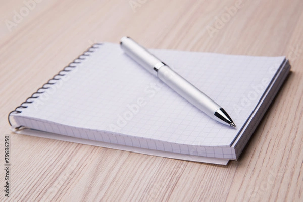 Fototapeta Blank notepad with pen on office wooden table