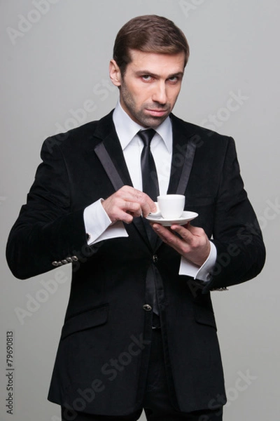 Fototapeta Portrait of attractive businessman drinking coffee