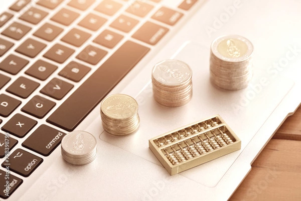 Obraz Money and abacus placed on a laptop