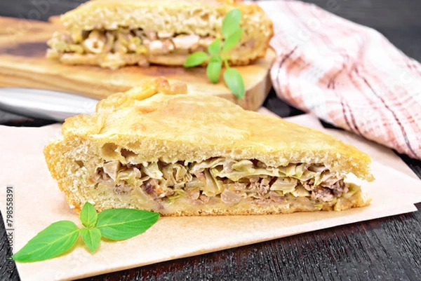 Fototapeta Pie with meat and cabbage on parchment