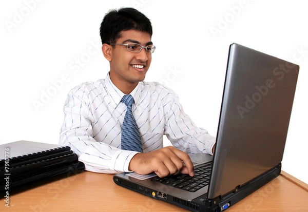 Obraz Young Indian business man working at his desk (Series)