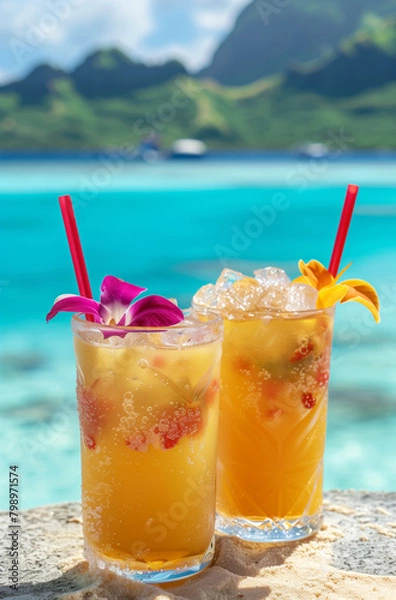 Fototapeta Exotic cocktails with tropical fruits in glasses with tropical coastline as a backdrop.