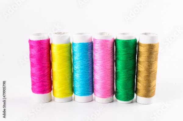 Fototapeta multicolor sewing threads on white background,