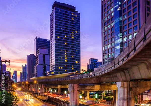 Fototapeta cityscape at dusk with sky train