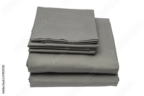 Fototapeta Folded bed linen on white isolated background